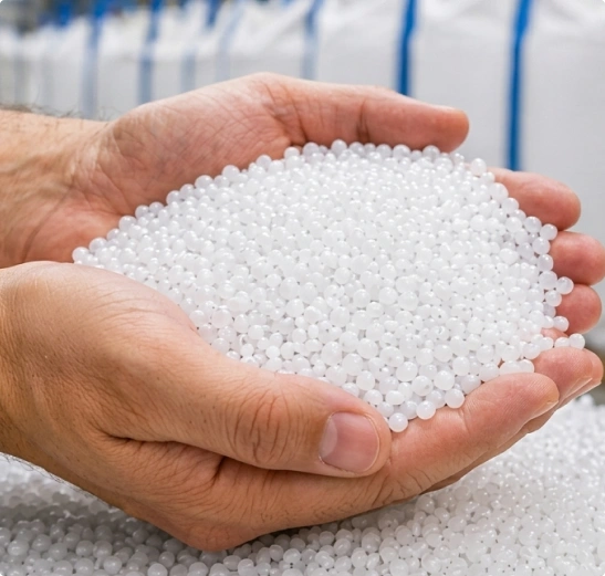 Industrial worker handling resin pellets